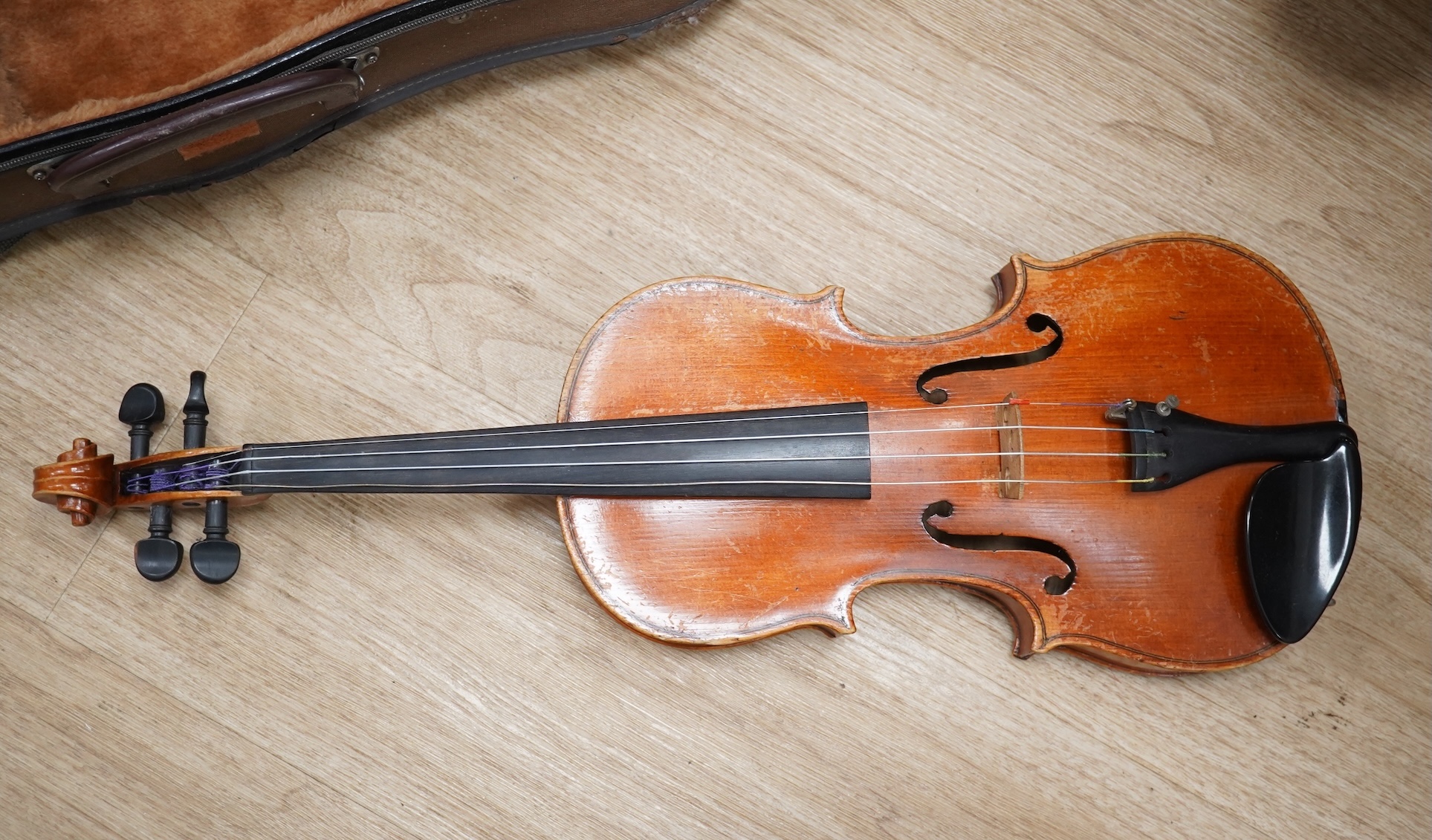 Two cased three quarter size violins, one labelled the London violin Co Ltd, length of back 33.5cm. Condition - both scratched